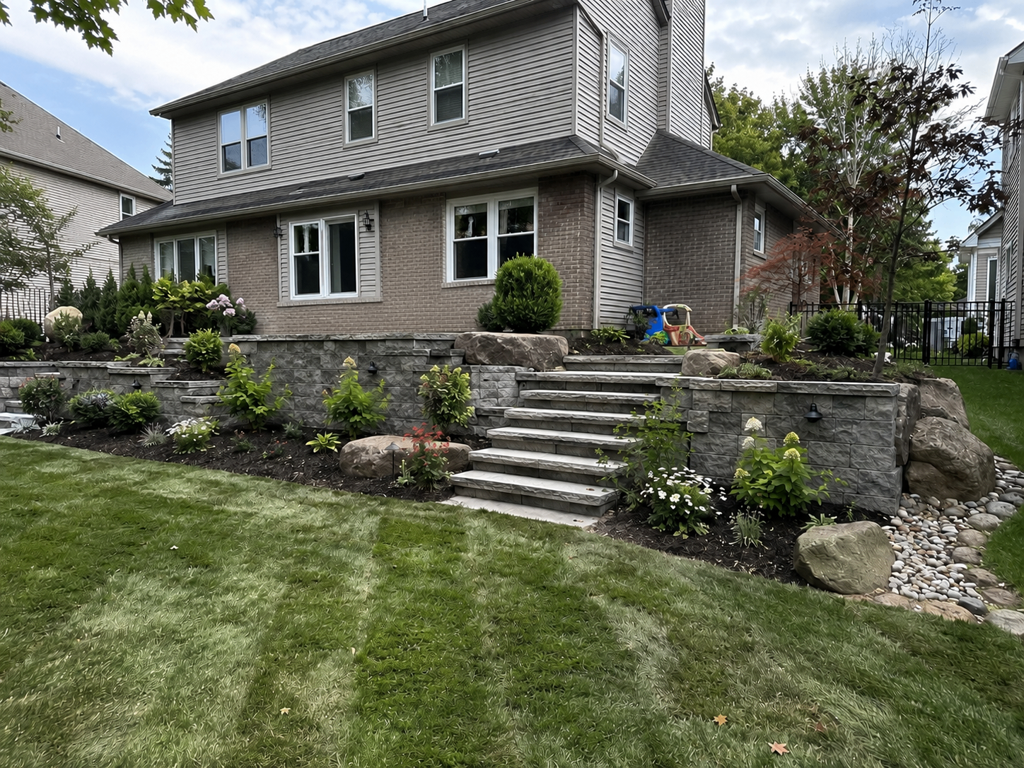Retaining wall and paver patio landscaping project in Greater Lansing, MI